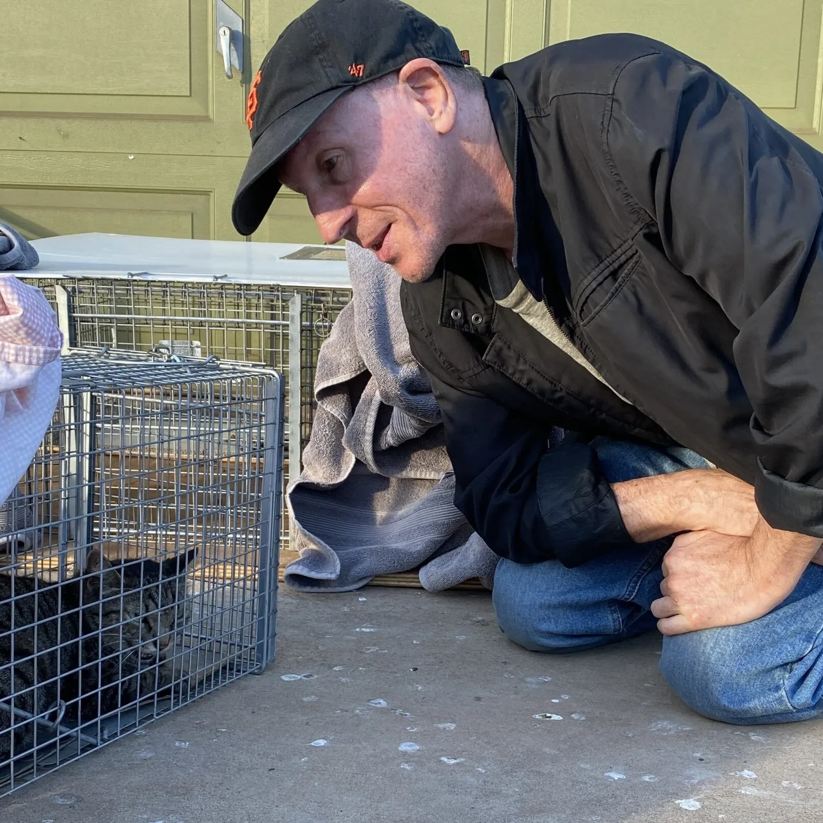 Bryan Kortis - Photo of him and feral cat in trap-cropped
