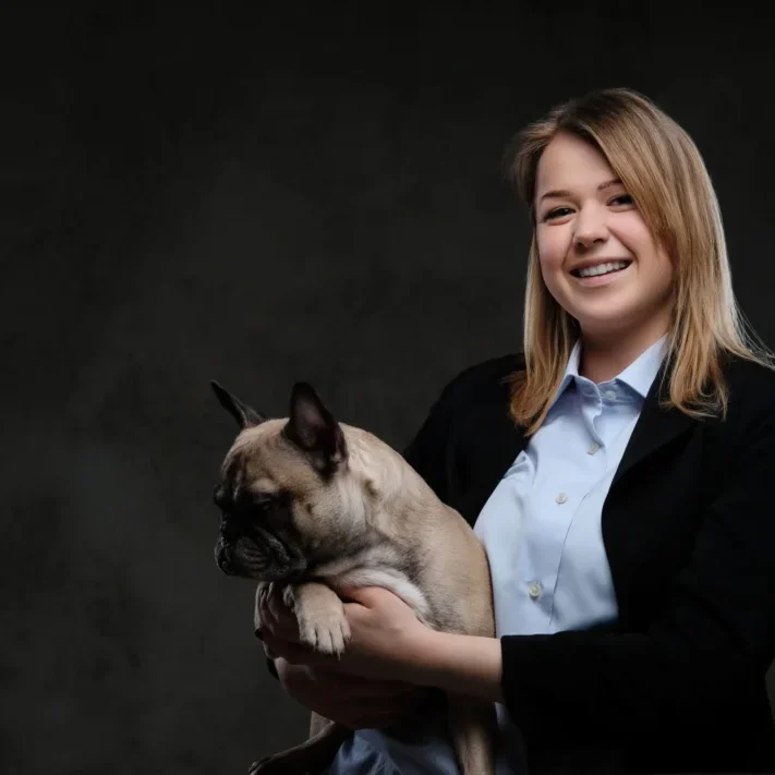 portrait-smiling-blonde-woman-breeder-holds-her-cute-pug-isolated-dark-textured-background